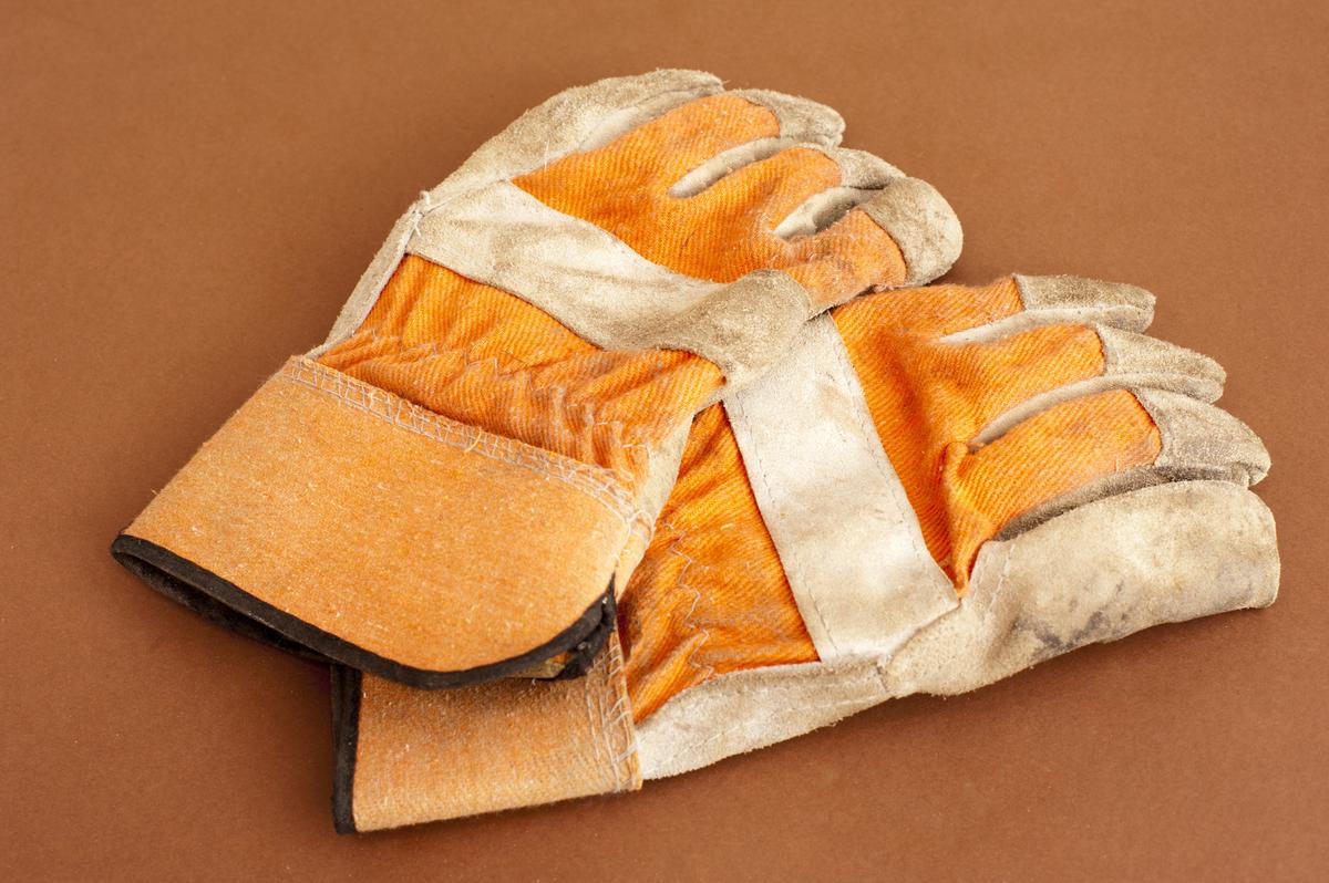 A variety of gardening gloves made from different materials such as leather, cotton, and rubber, showcasing the importance of selecting the right material for specific gardening tasks