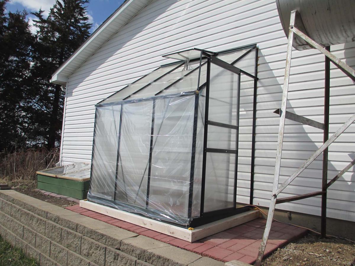 A selection of greenhouse kits and materials, including polycarbonate panels, aluminium frames, and modular designs, presented to showcase the range of options available.